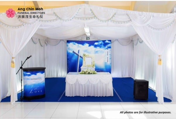 Modern Christian funeral service arrangement by Ang Chin Moh with simple white floral accents.