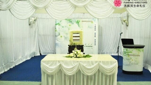Secular freethinker memorial setup by Ang Chin Moh featuring personalized photo displays.