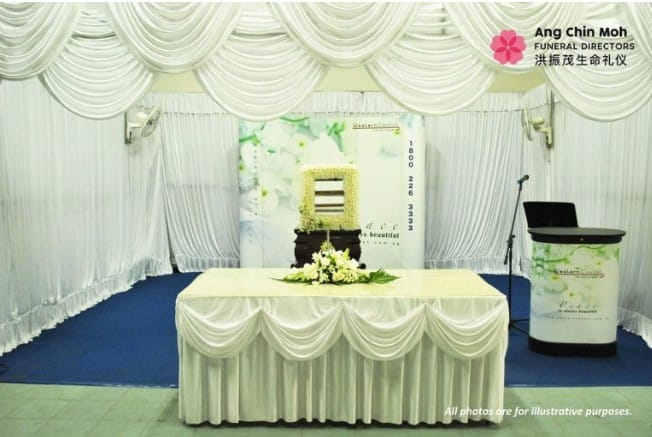 Secular freethinker memorial setup by Ang Chin Moh featuring personalized photo displays.
