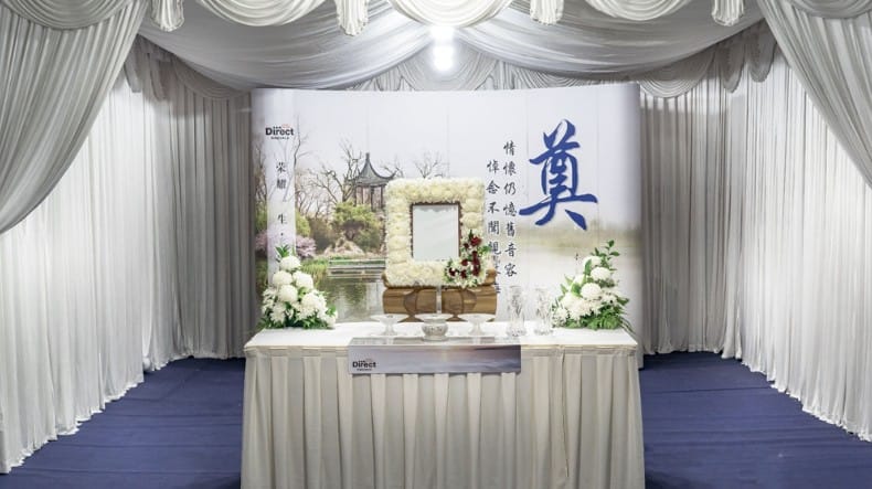 Traditional Taoist funeral wake setup with ceremonial altar and ritual floral decorations.