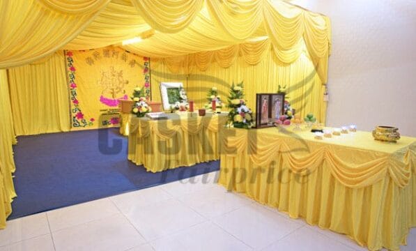 Traditional Buddhist funeral altar setup at Casket Fairprice parlors with ritual offerings.