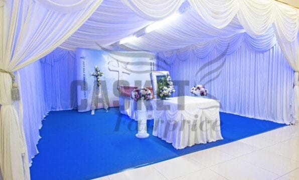 Modern Christian funeral service arrangement by Casket Fairprice with simple white floral accents.