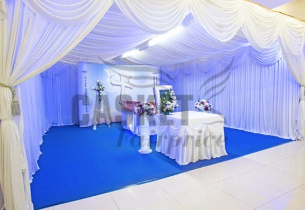 Modern Christian funeral service arrangement by Casket Fairprice with simple white floral accents.