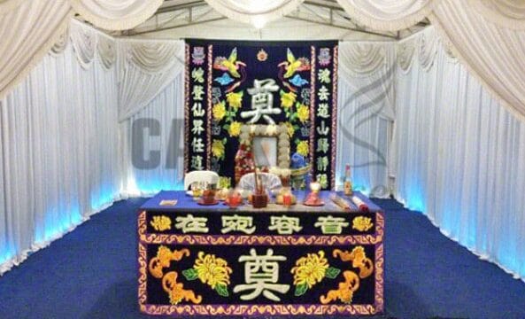 Traditional Buddhist funeral altar setup at Casket Fairprice parlors with ritual offerings.