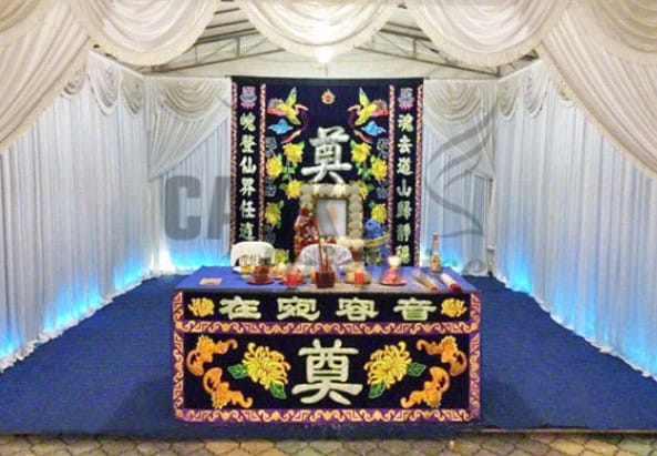 Traditional Buddhist funeral altar setup at Casket Fairprice parlors with ritual offerings.