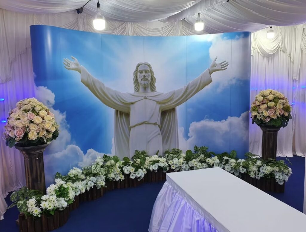Catholic funeral wake setup by Lee Teoh Heng Undertaker with religious statue and blue ambient lighting