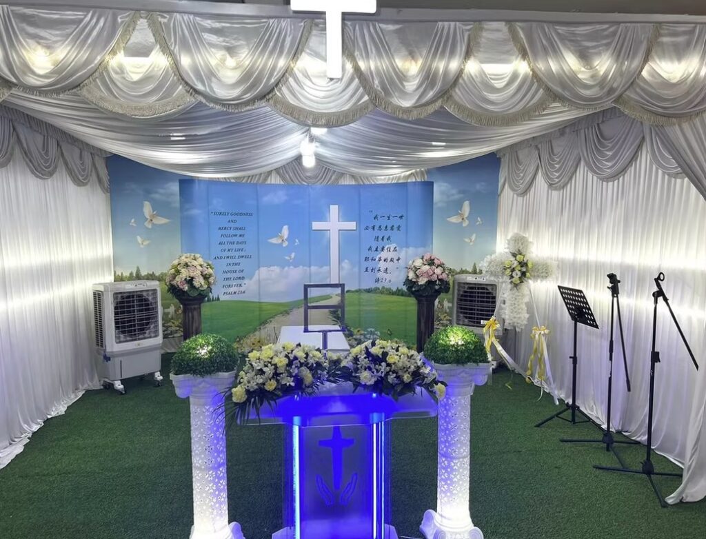 Christian funeral wake setup by Lee Teoh Heng Undertaker with white draping and cross backdrop