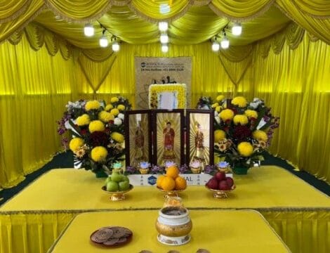 Buddhist funeral altar setup at Memorial Funeral with religious icons and floral arrangements.