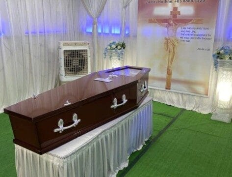 Catholic funeral wake setup at Memorial Funeral featuring elegant white drapes.