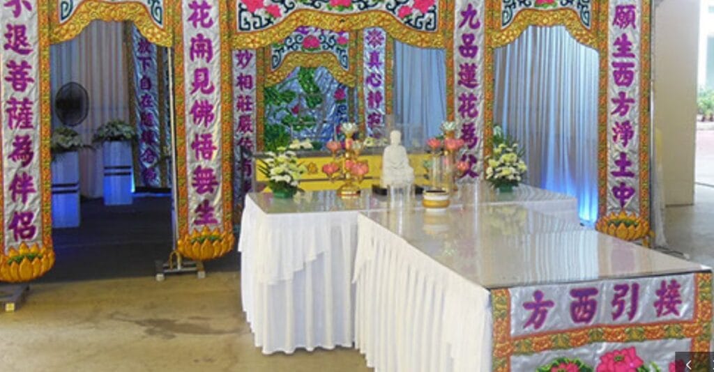 Traditional Buddhist funeral altar setup at Simplicity Casket with ritual offerings.