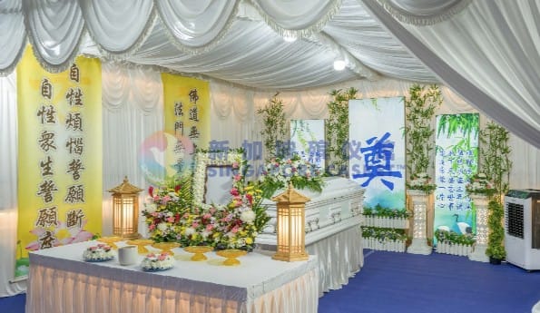 Taoist funeral wake setup at Singapore Casket including traditional banners and ceremonial altar.
