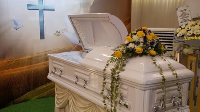 Christian funeral casket with floral arrangement by Eternity Funeral Service in Singapore