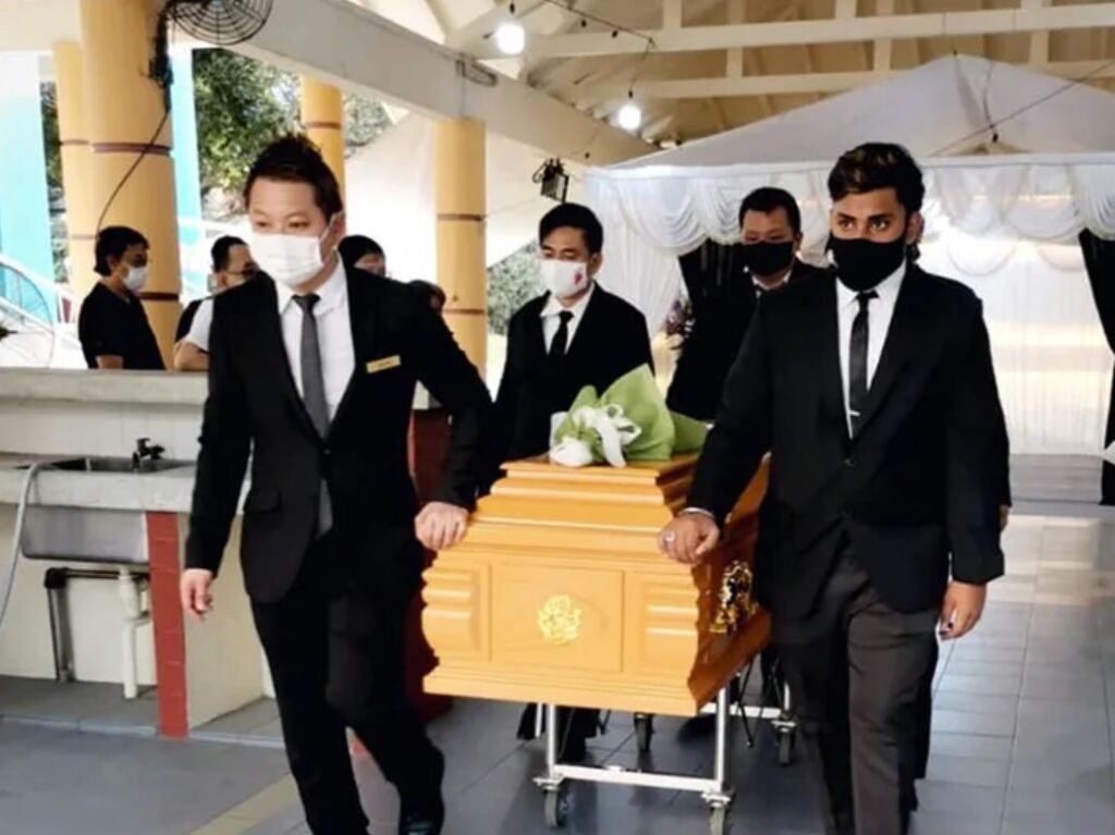 Funeral pallbearers carrying casket for Eternity Funeral Service in Singapore
