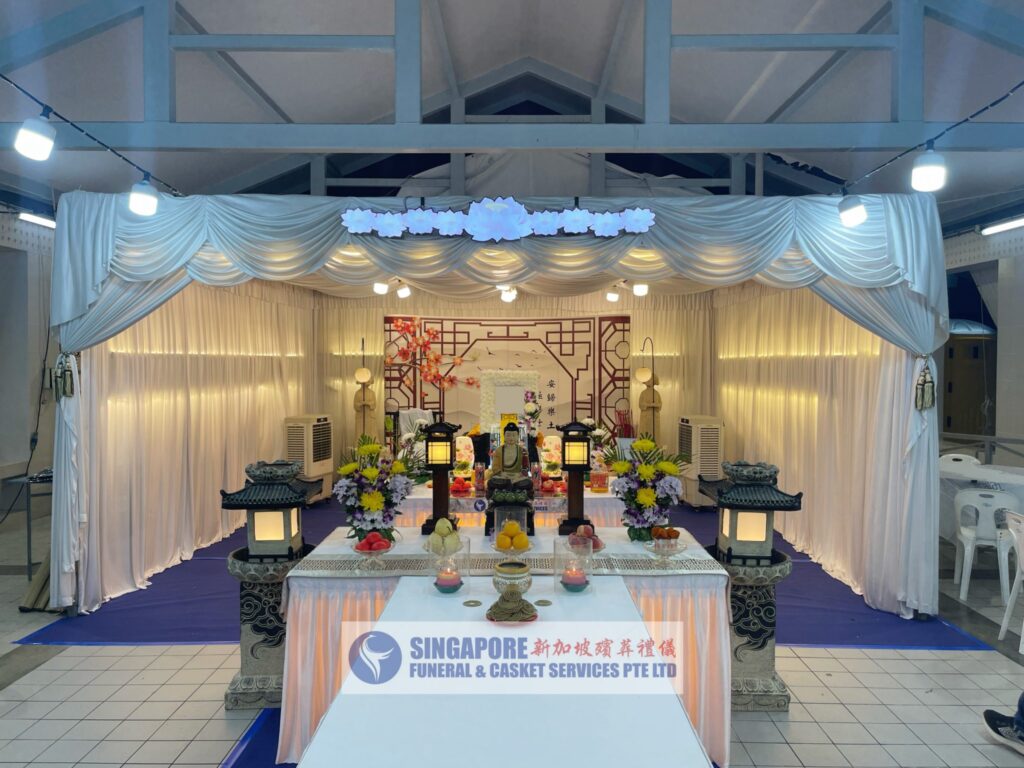 Buddhist funeral wake setup by Singapore Funeral & Casket Services with gold ceremonial altar