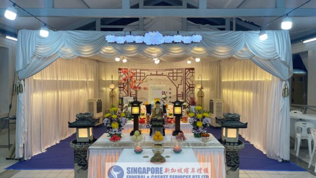 Buddhist funeral wake setup by Singapore Funeral & Casket Services with gold ceremonial altar