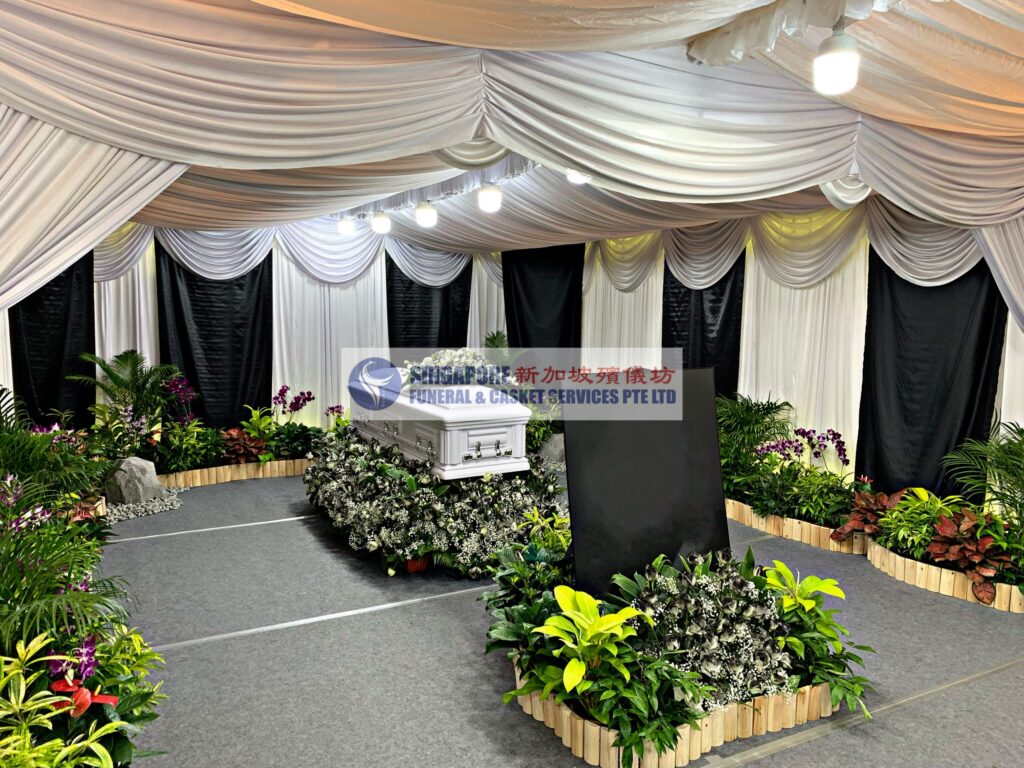 Free Thinker funeral wake setup by Singapore Funeral & Casket Services with white draping and floral arrangement