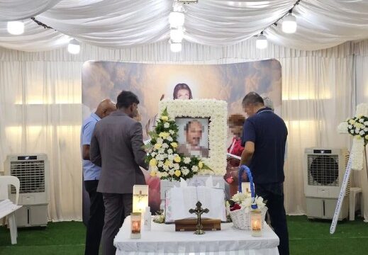 Catholic funeral wake setup by Unity Casket with floral altar arrangement in Singapore