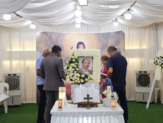 Catholic funeral wake setup by Unity Casket with floral altar arrangement in Singapore