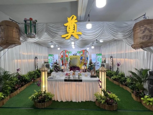 Taoist funeral wake setup by Unity Casket with traditional altar and deity figure in Singapore